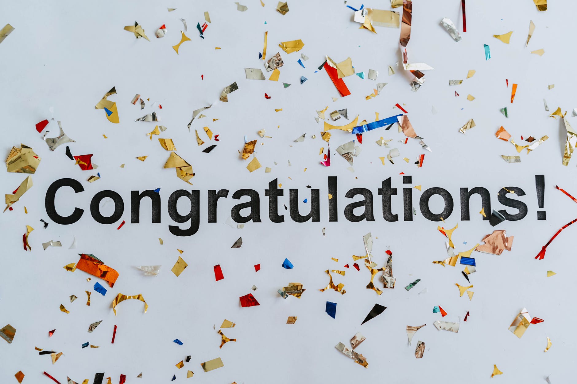 congratulations text on white surface with confetti
