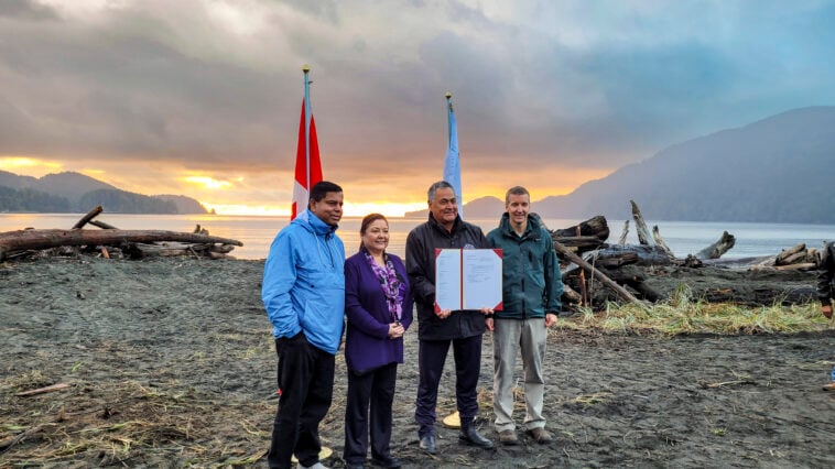 Gary Anandasangaree, Judi Thomas, Jeff Jones, and Dave Tovell, sign an agreement to return the use of ?A:?b?e:?s | Middle Beach to Pacheedaht First Nation near Port Renfrew, BC.