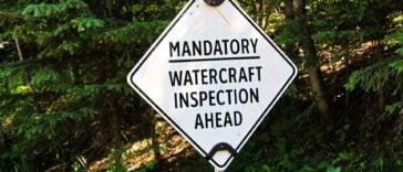 A sign that reads "mandatory watercraft inspection ahead"