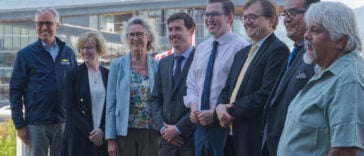 Representatives from the BC government and Federal government with BC-based spokespersons pose for a photo at the government's announcement of BC's fish farm transition transition plan.