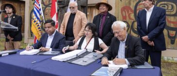 Assembled leaders and elected officials sign landmark agreement with two First Nations