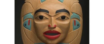 Dale Campbell's "Woman who Brought the Salmon" mask made of alder, abalone and pigment.